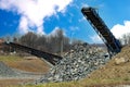 Crushing machinery, cone type rock crusher, conveying crushed granite gravel stone in a quarry open pit mining processing plant