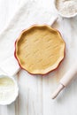 Crust on baking sheet , pots with wheat and bran flour and rolling pin on white wooden table