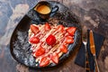 Crusted strawberry Crepe with white chocolate with whipped cream, knife and fork served in dish  on dark background Royalty Free Stock Photo