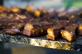 Crusty grilled pork ribs on metal lattice at bbq party Royalty Free Stock Photo