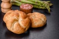 Crusty round bread rolls, known as Kaiser or Vienna rolls on a cutting board Royalty Free Stock Photo