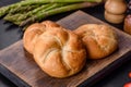 Crusty round bread rolls, known as Kaiser or Vienna rolls on a cutting board Royalty Free Stock Photo