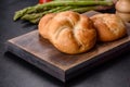 Crusty round bread rolls, known as Kaiser or Vienna rolls on a cutting board Royalty Free Stock Photo