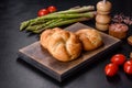 Crusty round bread rolls, known as Kaiser or Vienna rolls on a cutting board Royalty Free Stock Photo