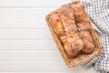 Crusty rustic baguette in basket on white table. Top view Royalty Free Stock Photo