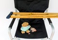 Crutches for patient, pills, teddy bear with mask on face, injection syringe on black chair, health insurance concept