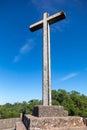 The Cruz Alta viewpoint is the higest point in the Bussaco range in Portugal. The cross monument is under a blue sky