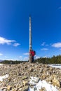 Cruz de Ferro, Spain - A Pilgrim Embracing the Iron Cross - Cruz de Ferro - the Highest Point on the Way of St James el Camino