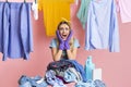 Cry of despair from housewife. Girl with heap of dirty clothes