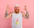 Cry man with beard and tattoos acts like a small newborn Royalty Free Stock Photo