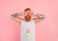 Cry man with beard and tattoos acts like a small newborn Royalty Free Stock Photo