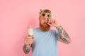 Cry man with beard and tattoos eats a big icecream Royalty Free Stock Photo