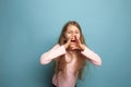 The cry. Teen girl on a blue background. Facial expressions and people emotions concept