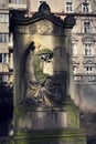 Crying angel organist tombstone on Malostransky cemetery, Prague, Czech republic