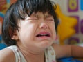 A crying little Asian baby girl with tears Royalty Free Stock Photo