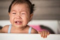 Crying baby in bed Royalty Free Stock Photo