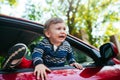 Crying baby boy in car. The boy is crying and wants to get out of the maniche Royalty Free Stock Photo