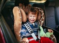 Crying baby boy in a safety car seat Royalty Free Stock Photo