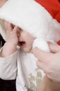 Crying baby with christmas hat