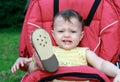 Crying baby girl sitting in stroller Royalty Free Stock Photo