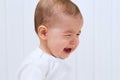 Crying beautiful baby on white background