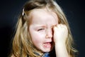 Crying blond little girl with focus on her tears Royalty Free Stock Photo