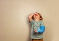 Crying boy with broken hand stand over wall Royalty Free Stock Photo