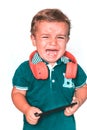 Crying child with red neckband and blue polo shirt