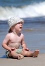 Craing little boy sitting on the beach Royalty Free Stock Photo