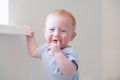 Crying ginger boy with atopic dermatitis Royalty Free Stock Photo