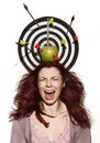 Crying girl portrait with apple, darts and arrows