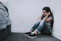 Crying Girl Sits on Floor Closes Ears and Eyes Royalty Free Stock Photo