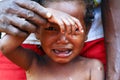 Crying girl with tear on cheek - poor african child Royalty Free Stock Photo