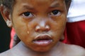 Crying girl with tear on cheek - poor african child Royalty Free Stock Photo