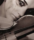 Crying girl and violin Royalty Free Stock Photo