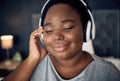 Crying, happy and black woman with headphones for music, sound or audio. Tears, radio and plus size African person
