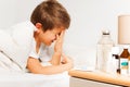 Crying kid boy laying in hospital ward or room bed Royalty Free Stock Photo