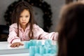 Crying little girl tries to remove the hair curlers herself