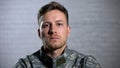 Crying male soldier looking at camera, military posttraumatic syndrome, problem