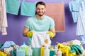 Crying man in blue T-shirt holding his favourite T-shirt with spot of grease