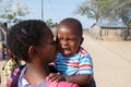 Crying namibian child with mother