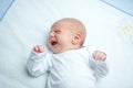 Crying newborn baby on changing table. Cute little girl or boy two weeks old. Dry and healthy body and skin concept Royalty Free Stock Photo