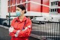 Crying paramedic in front of isolation hospital facility.Mental melt down of medical professional.Emergency room doctor in fear Royalty Free Stock Photo