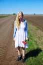 Crying russian girl in field near road