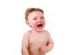 Crying screaming toddler baby boy is lying on the bed, isolated on a wh Royalty Free Stock Photo