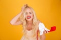 Crying screaming young blonde woman talking by telephone. Royalty Free Stock Photo