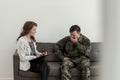Crying soldier in green uniform during consultation with psychologist Royalty Free Stock Photo