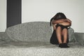 Crying woman abused as young feeling depressed and miserable while she sitting alone in her room Royalty Free Stock Photo