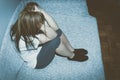 Crying woman abused as young feeling depressed and miserable while she sitting alone in her room