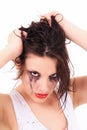 Crying young woman with flowed mascara Royalty Free Stock Photo